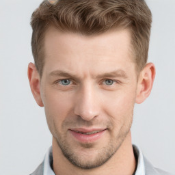 Joyful white adult male with short  brown hair and grey eyes