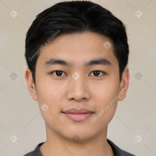 Joyful asian young-adult male with short  black hair and brown eyes