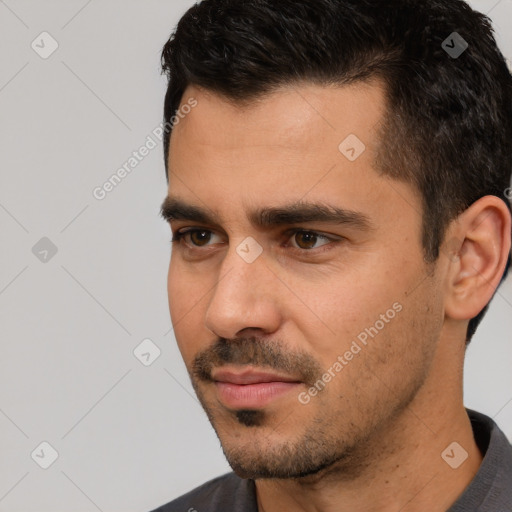 Joyful white young-adult male with short  black hair and brown eyes