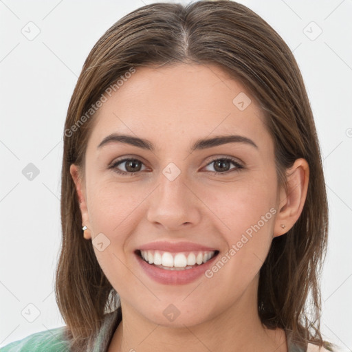 Joyful white young-adult female with long  brown hair and grey eyes