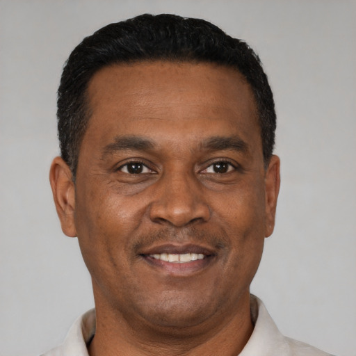 Joyful latino adult male with short  black hair and brown eyes