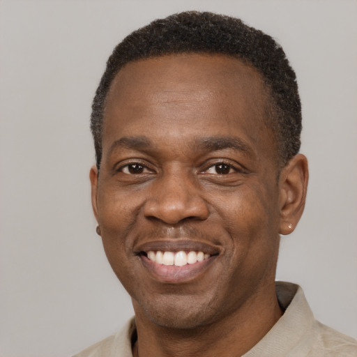 Joyful latino adult male with short  brown hair and brown eyes