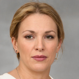 Joyful white adult female with medium  brown hair and grey eyes