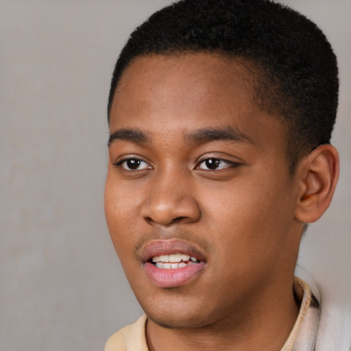 Joyful black young-adult male with short  brown hair and brown eyes
