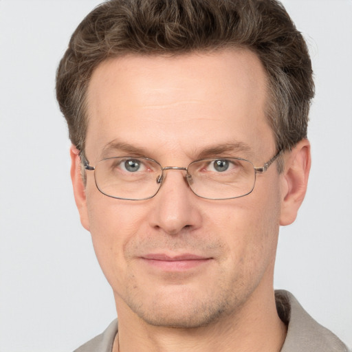 Joyful white adult male with short  brown hair and grey eyes