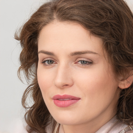 Joyful white young-adult female with medium  brown hair and green eyes