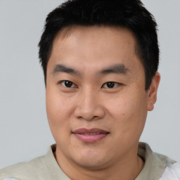 Joyful asian young-adult male with short  black hair and brown eyes