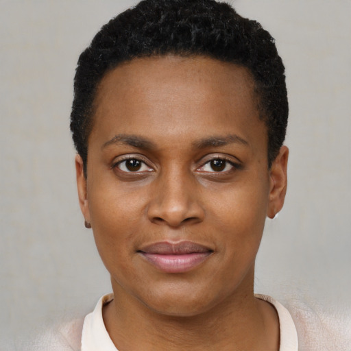 Joyful black young-adult female with short  brown hair and brown eyes
