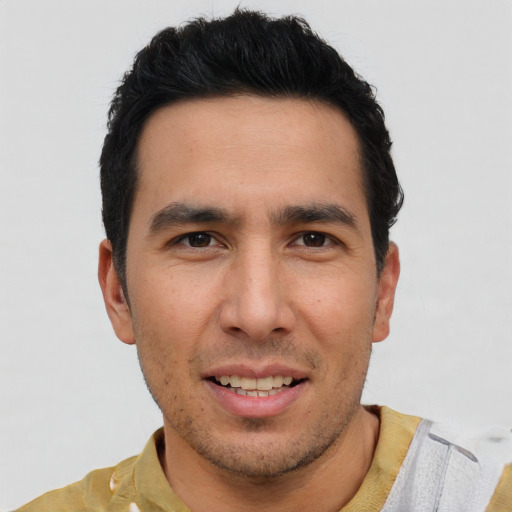 Joyful white young-adult male with short  black hair and brown eyes