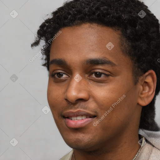 Joyful black young-adult male with short  black hair and brown eyes