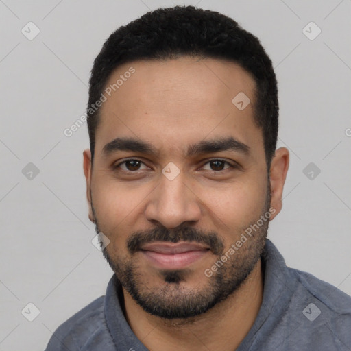 Joyful latino young-adult male with short  black hair and brown eyes