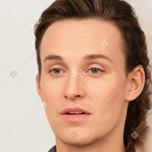 Joyful white young-adult male with medium  brown hair and brown eyes