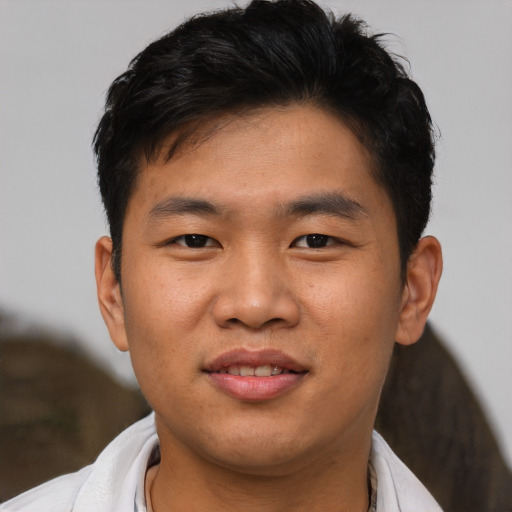 Joyful asian young-adult male with short  black hair and brown eyes