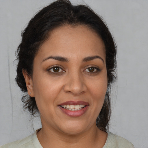 Joyful white adult female with medium  brown hair and brown eyes