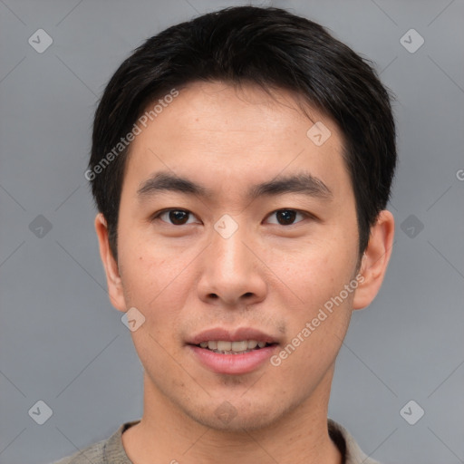 Joyful asian young-adult male with short  brown hair and brown eyes