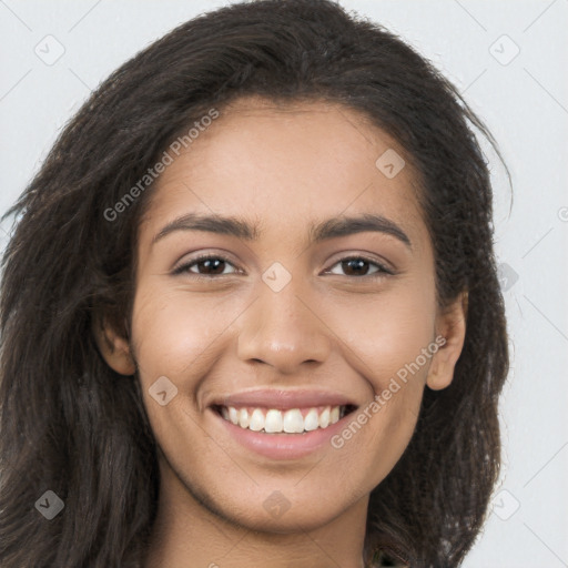 Joyful latino young-adult female with long  brown hair and brown eyes