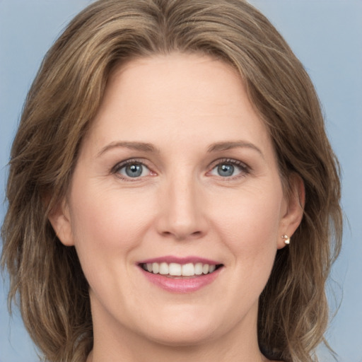 Joyful white young-adult female with medium  brown hair and green eyes