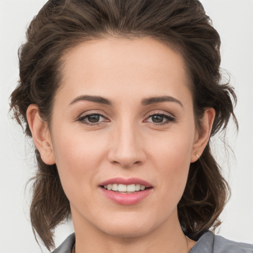 Joyful white young-adult female with medium  brown hair and grey eyes