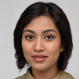 Joyful latino young-adult female with medium  brown hair and brown eyes