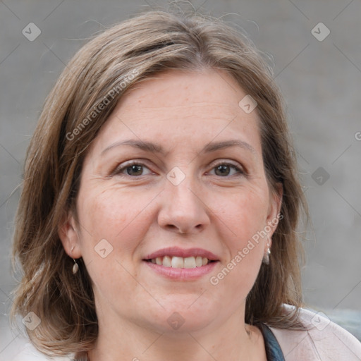 Joyful white adult female with medium  brown hair and grey eyes