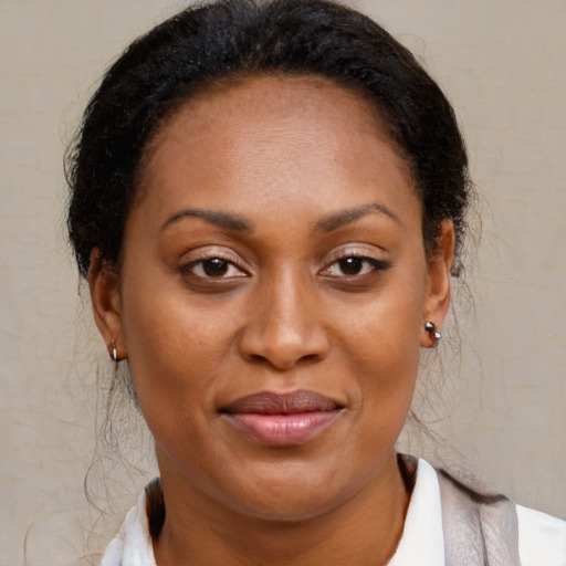 Joyful black young-adult female with medium  brown hair and brown eyes