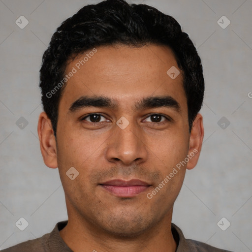 Joyful latino young-adult male with short  black hair and brown eyes