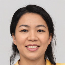 Joyful asian young-adult female with medium  brown hair and brown eyes