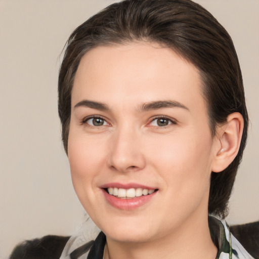 Joyful white young-adult female with medium  brown hair and brown eyes