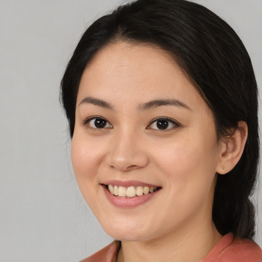 Joyful asian young-adult female with medium  black hair and brown eyes