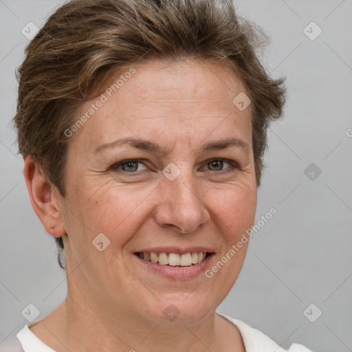 Joyful white adult female with short  brown hair and brown eyes