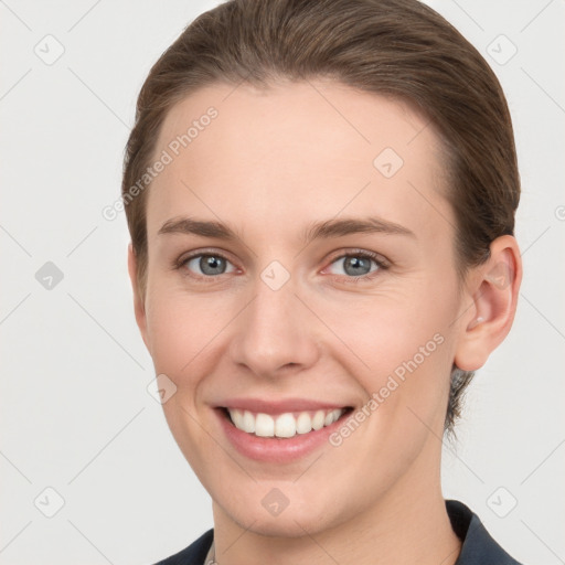 Joyful white young-adult female with short  brown hair and grey eyes