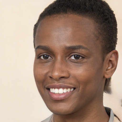 Joyful black young-adult female with short  brown hair and brown eyes