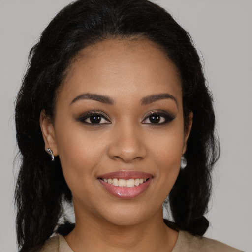 Joyful latino young-adult female with long  brown hair and brown eyes