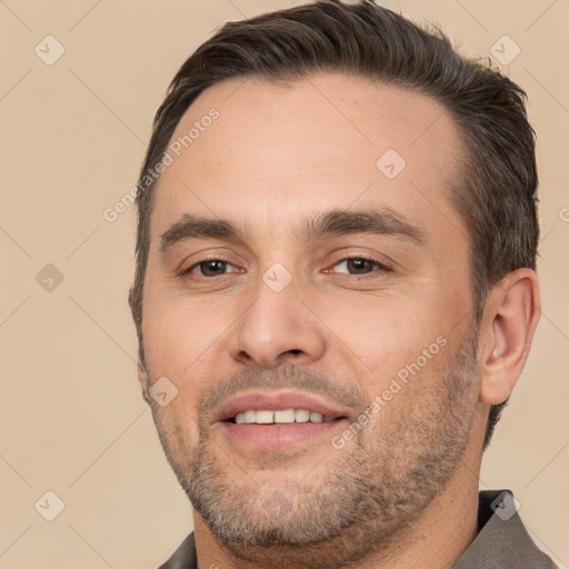 Joyful white adult male with short  brown hair and brown eyes