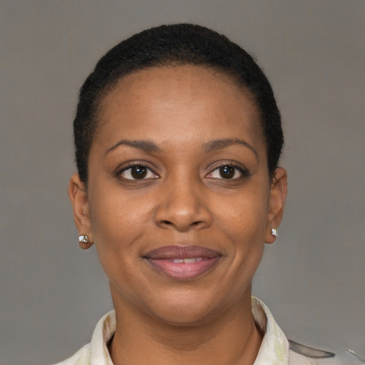 Joyful black young-adult female with short  brown hair and brown eyes