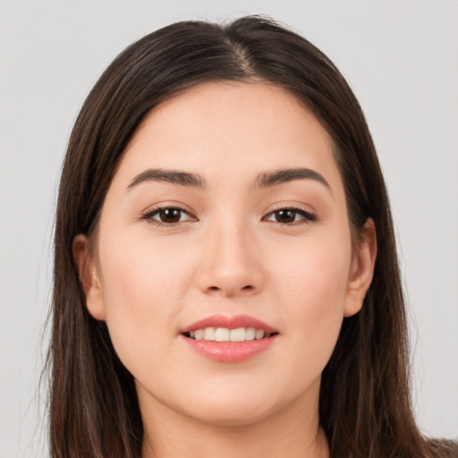 Joyful white young-adult female with long  brown hair and brown eyes