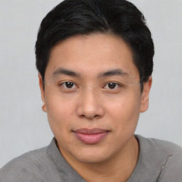 Joyful asian young-adult male with short  black hair and brown eyes