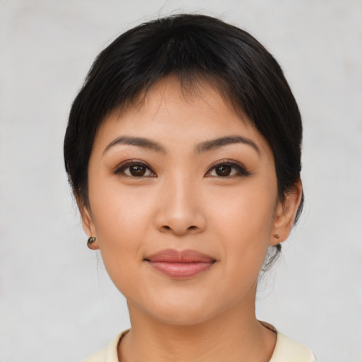 Joyful asian young-adult female with medium  brown hair and brown eyes
