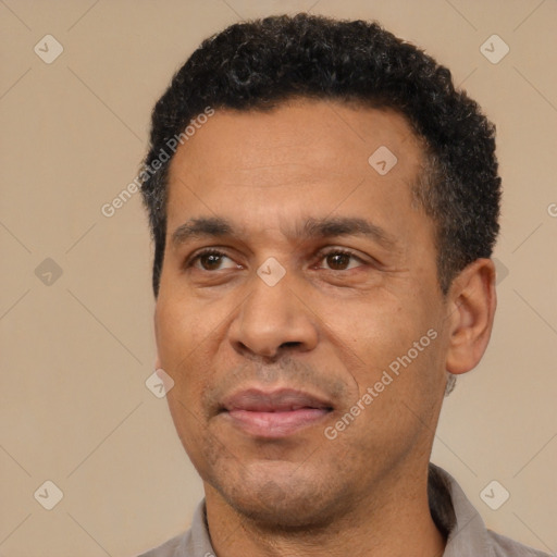 Joyful latino adult male with short  black hair and brown eyes