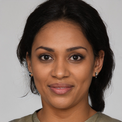 Joyful black young-adult female with medium  black hair and brown eyes