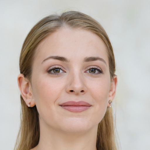 Joyful white young-adult female with long  brown hair and blue eyes