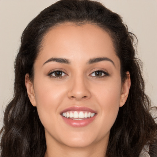 Joyful white young-adult female with long  brown hair and brown eyes