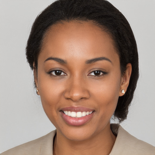 Joyful black young-adult female with medium  black hair and brown eyes