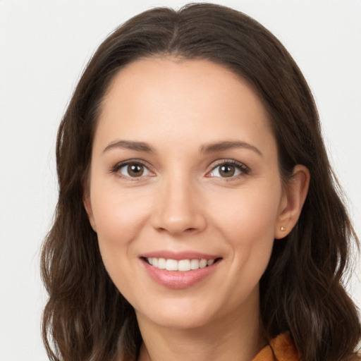 Joyful white young-adult female with long  brown hair and brown eyes