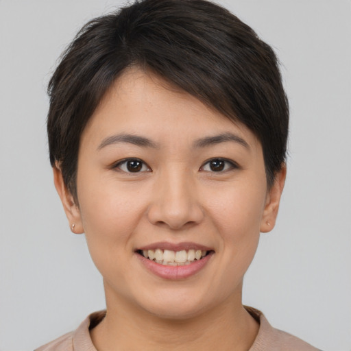 Joyful asian young-adult female with short  brown hair and brown eyes