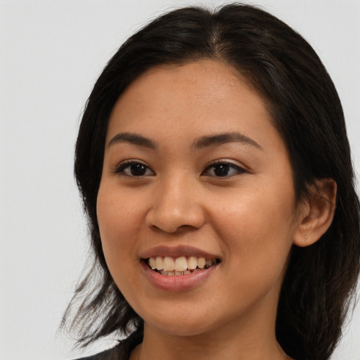 Joyful latino young-adult female with medium  brown hair and brown eyes