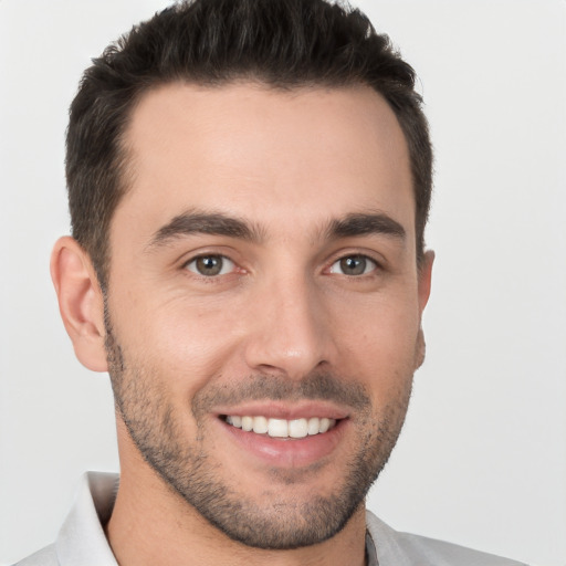 Joyful white young-adult male with short  brown hair and brown eyes