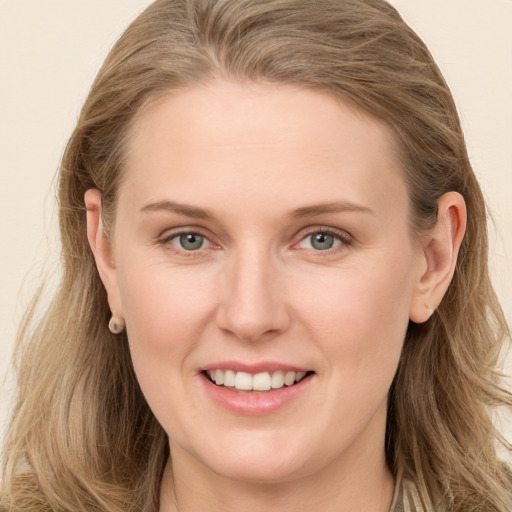 Joyful white young-adult female with long  brown hair and grey eyes