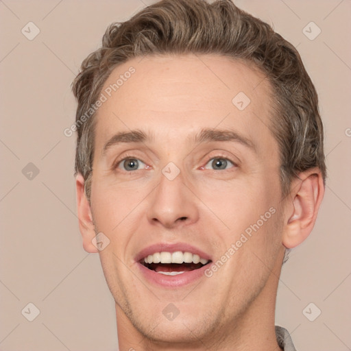 Joyful white adult male with short  brown hair and grey eyes