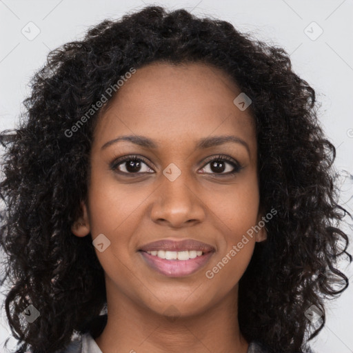 Joyful black young-adult female with long  brown hair and brown eyes